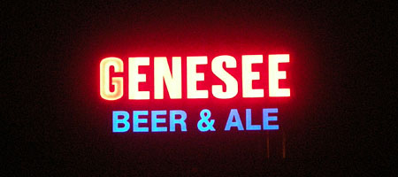 Genesee Beer Sign lit up over the Genesee River
