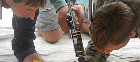 John Dodd and Fran Dodd installing John Dodd's benches in front of City Newspaper in the Neighborhood of the Arts in Rochester, New York