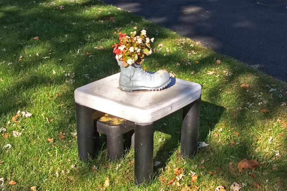 Boot with flowers on plastic table