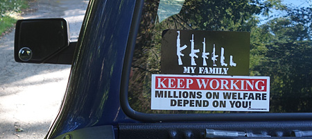 Pick-up truck with bumper stickers near Park