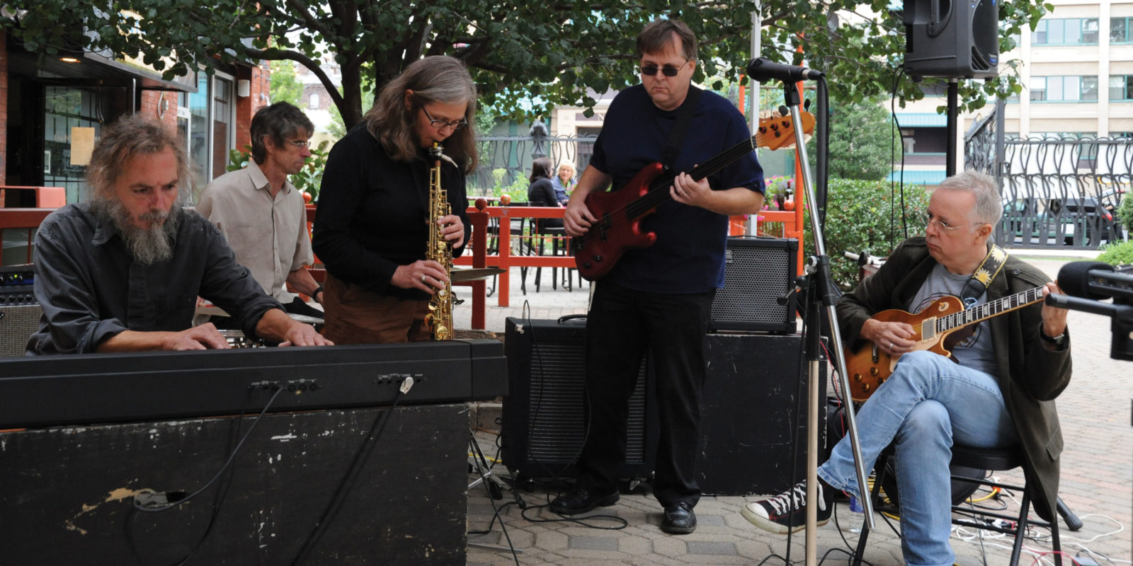 Margaret Explosion with Pete LaBonne performing live at Village Gate courtyard. Photo by Brian Peterson.