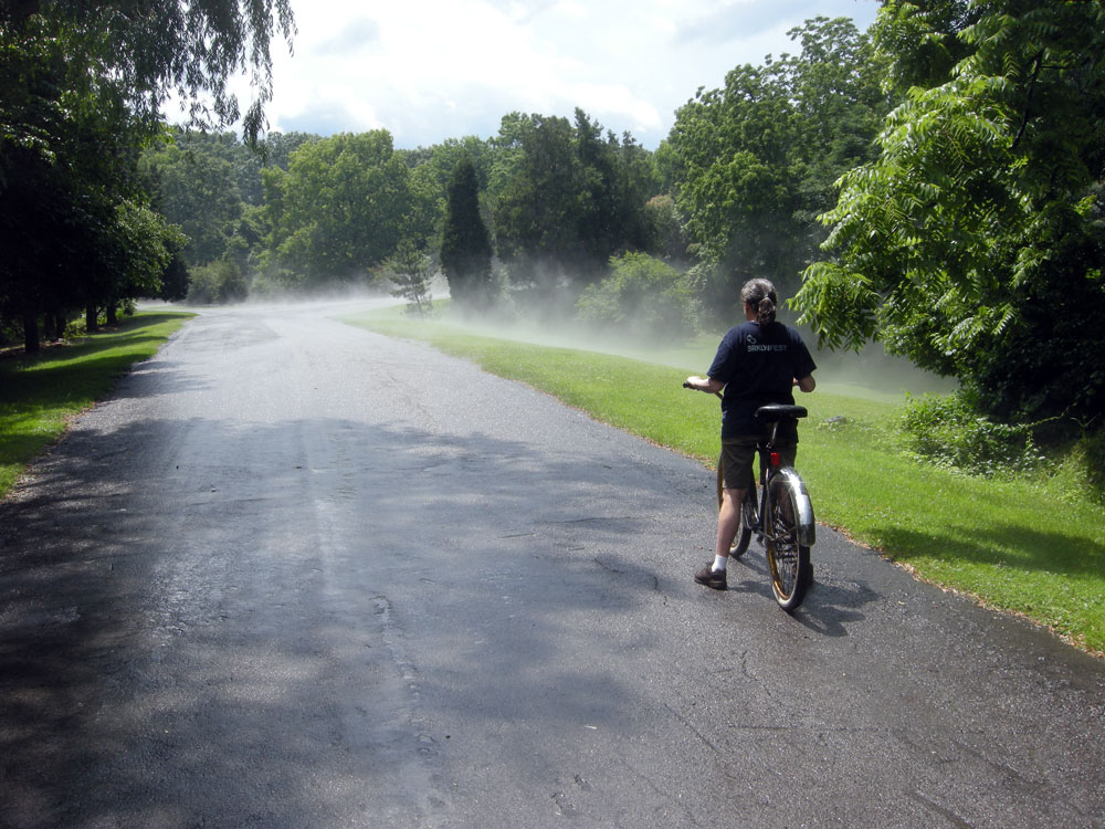 Peggi riding bike in steam after the the rain