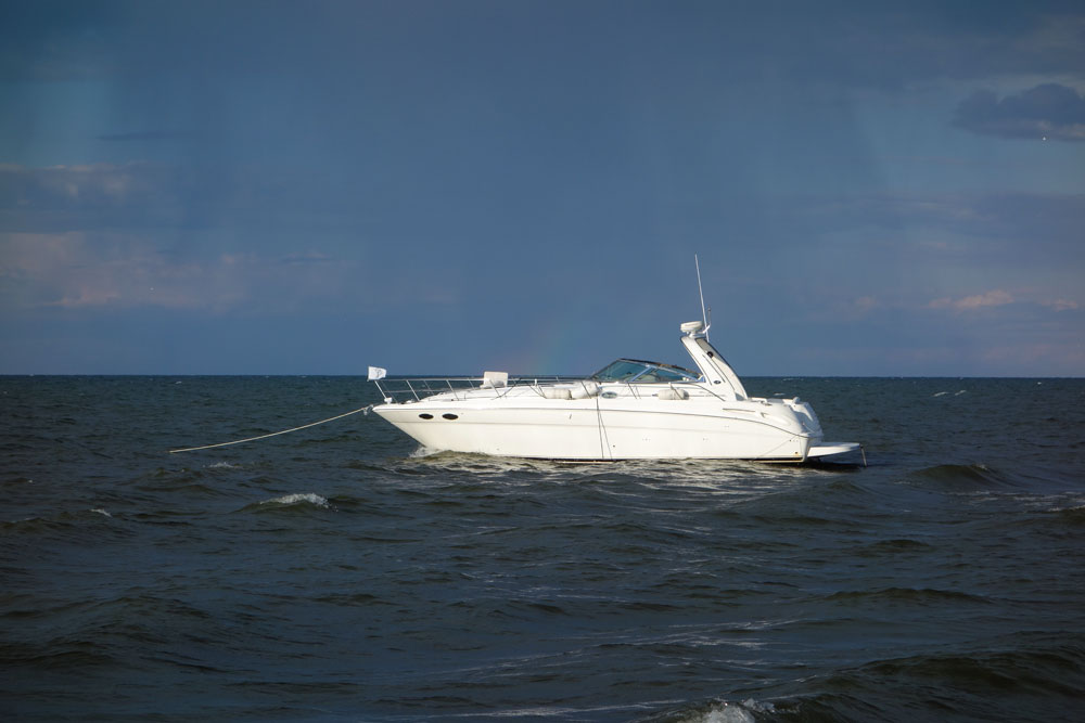 White boat offshore on Crescent Beach
