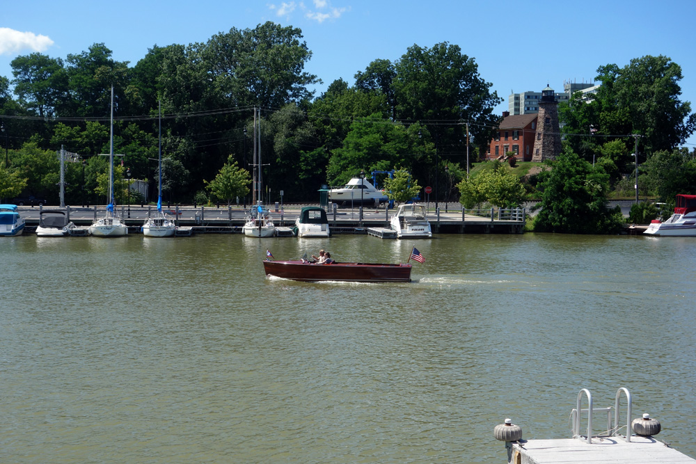 Wooden inboard motorboat on Genesee River from Schooners