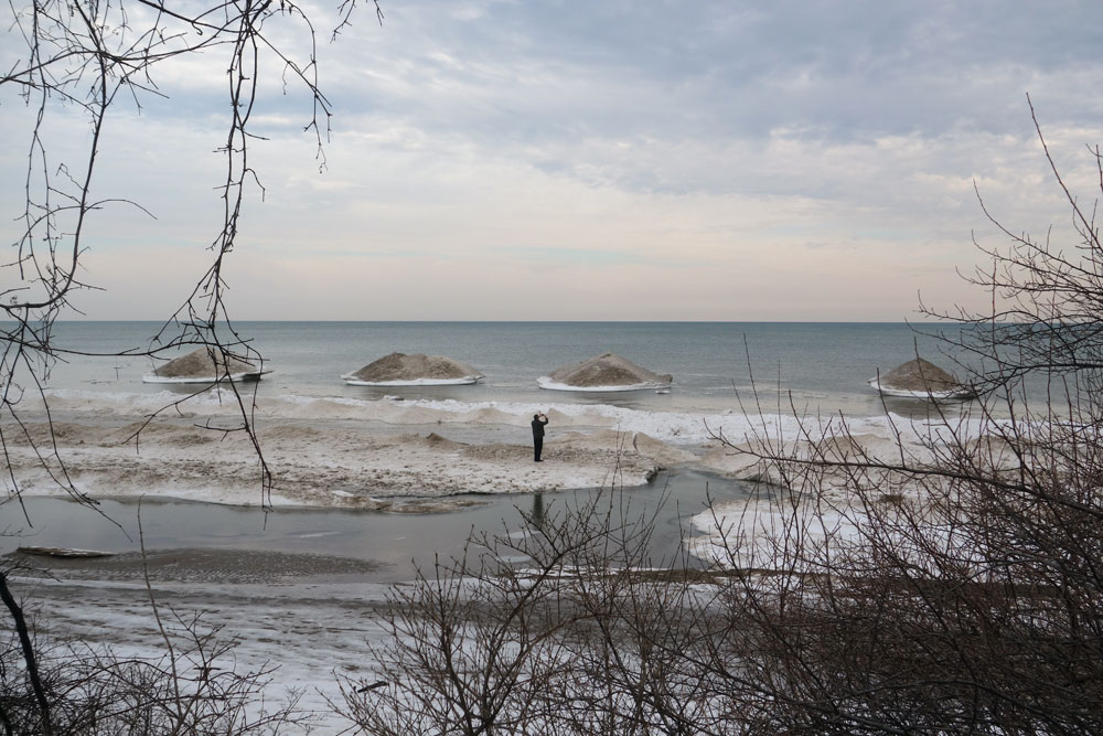 Man with camera on Lake Ontario, Rochester, New York
