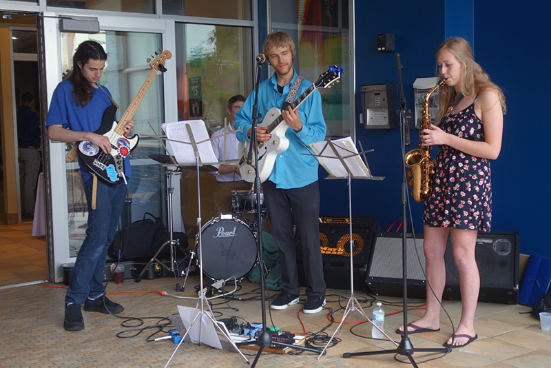 Young trio in front of Spot Coffee performing at the 2018 Rochester International Jazz Festival