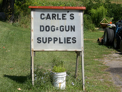 Carle Dog And Gun Sign