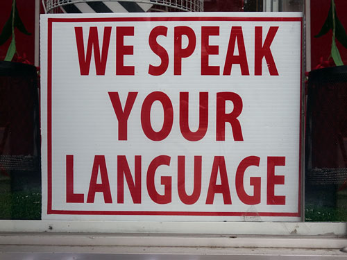 We Speak Your Language sign