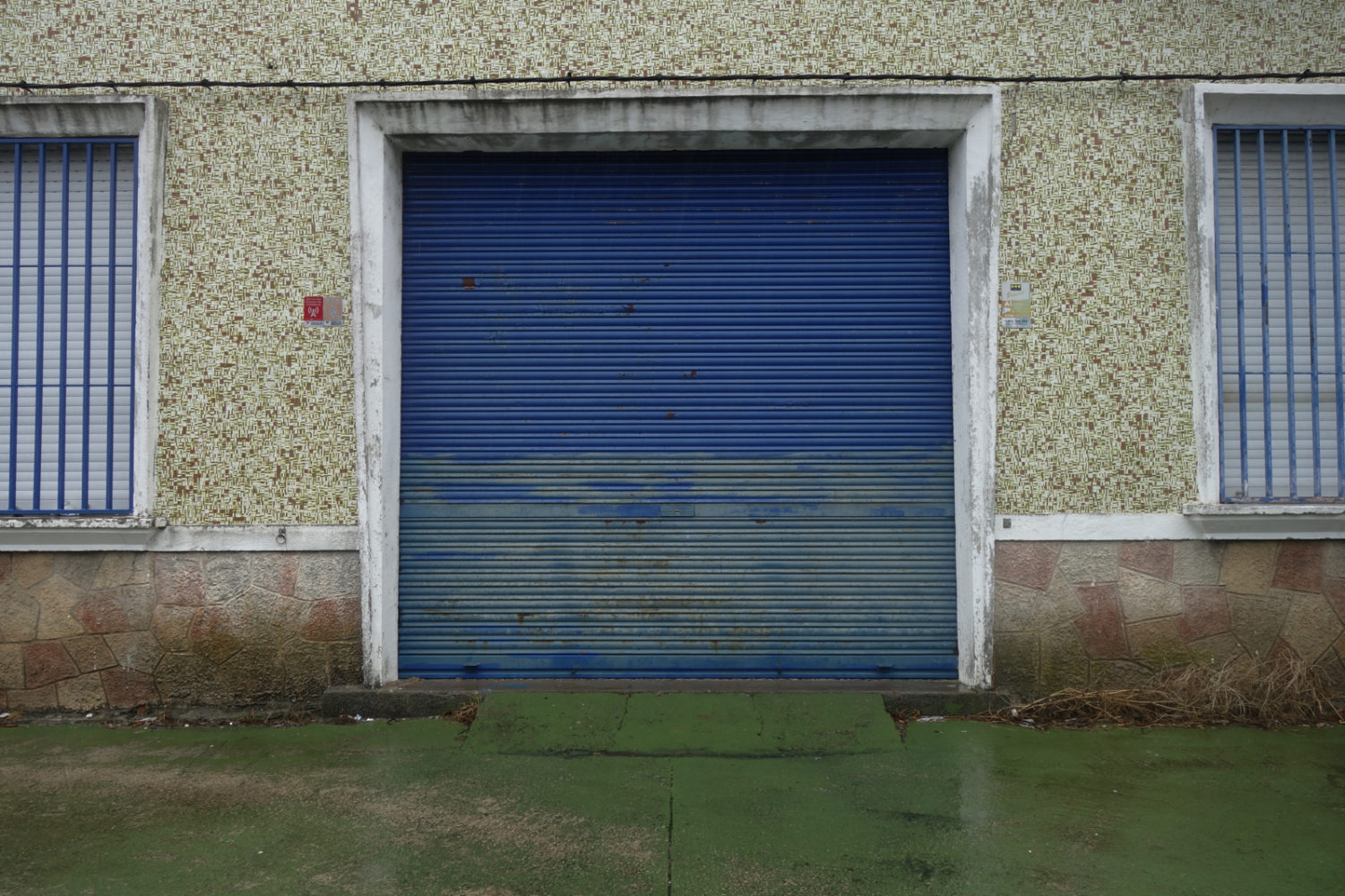 Blue door and green walk along Camino Portuguese