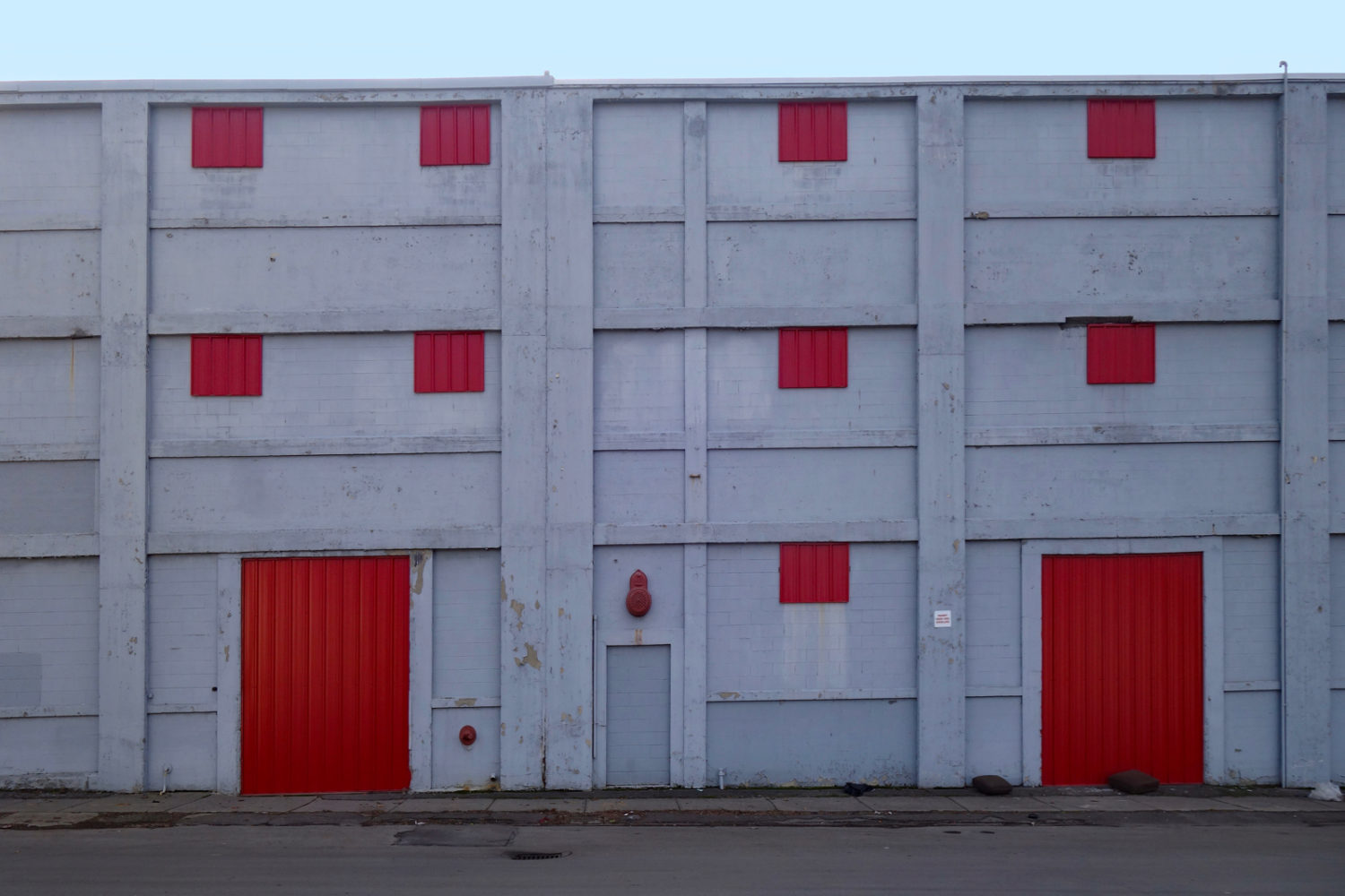 Red and gray building across the street from Saxon Studio near the Public Market