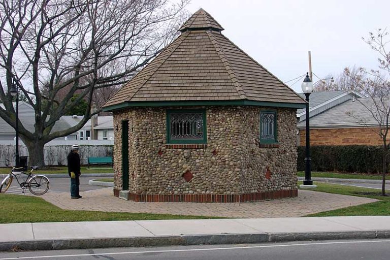 The town of Irondequoit moved this old cobblestone smokehouse from the Fire Department near Ridge down Culver to this empty lot that they have now named Oscar "Ollie" Roth Park. It is more like a parking lot since they paved the whole thing. They put new windows in it and it is now the world's smallest art gallery. Culver Road in Rochester, New York.