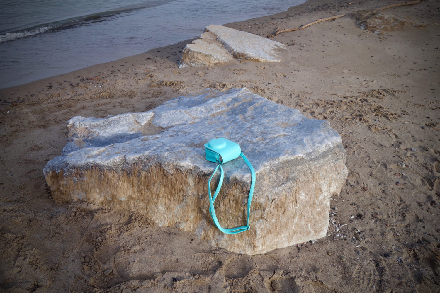 Turquoise camera case on Durand Eastman beach