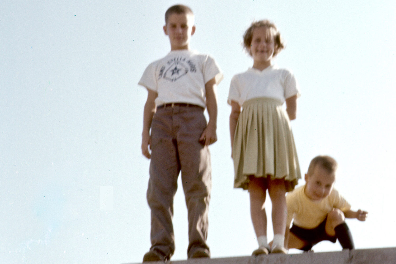 Paul, Ann and John standing on foundation of our new home on Hawley Drive in Webstaret, NY