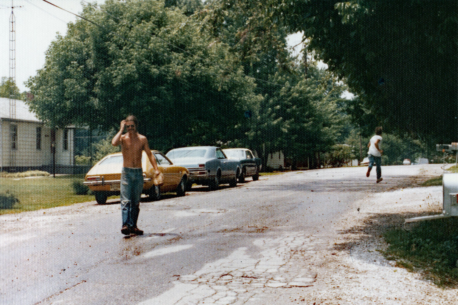 Norm and Steve playing catch in fromt of Milton house