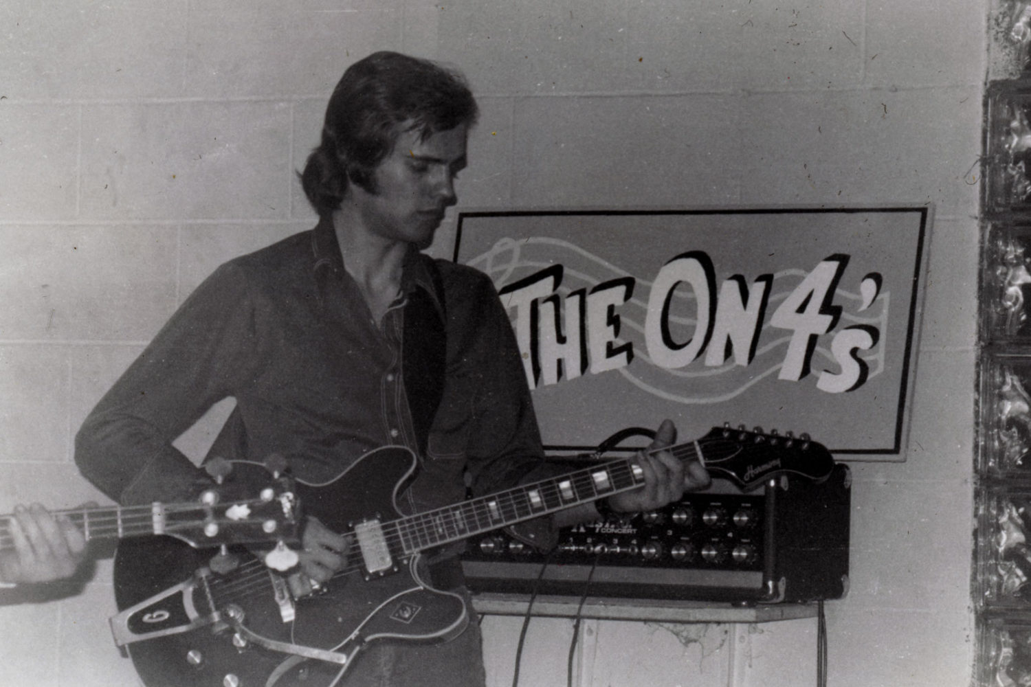 Lead guitar player, Danny, with On Fours sign