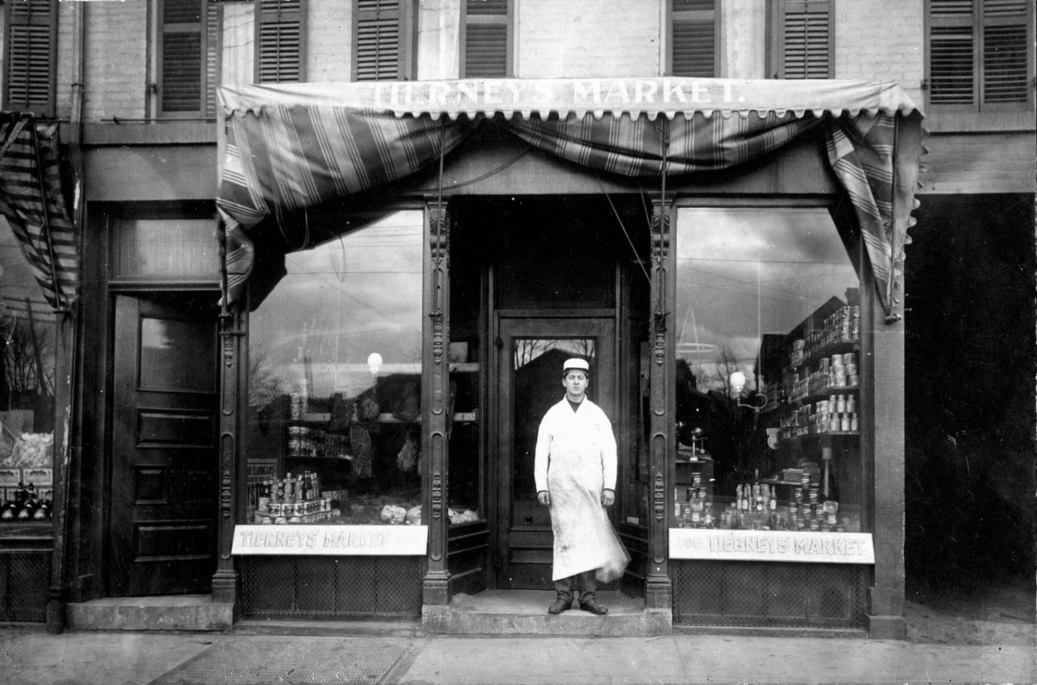 Ray Tierney in front of his first store 312 North Street in Rochester, New York  1906