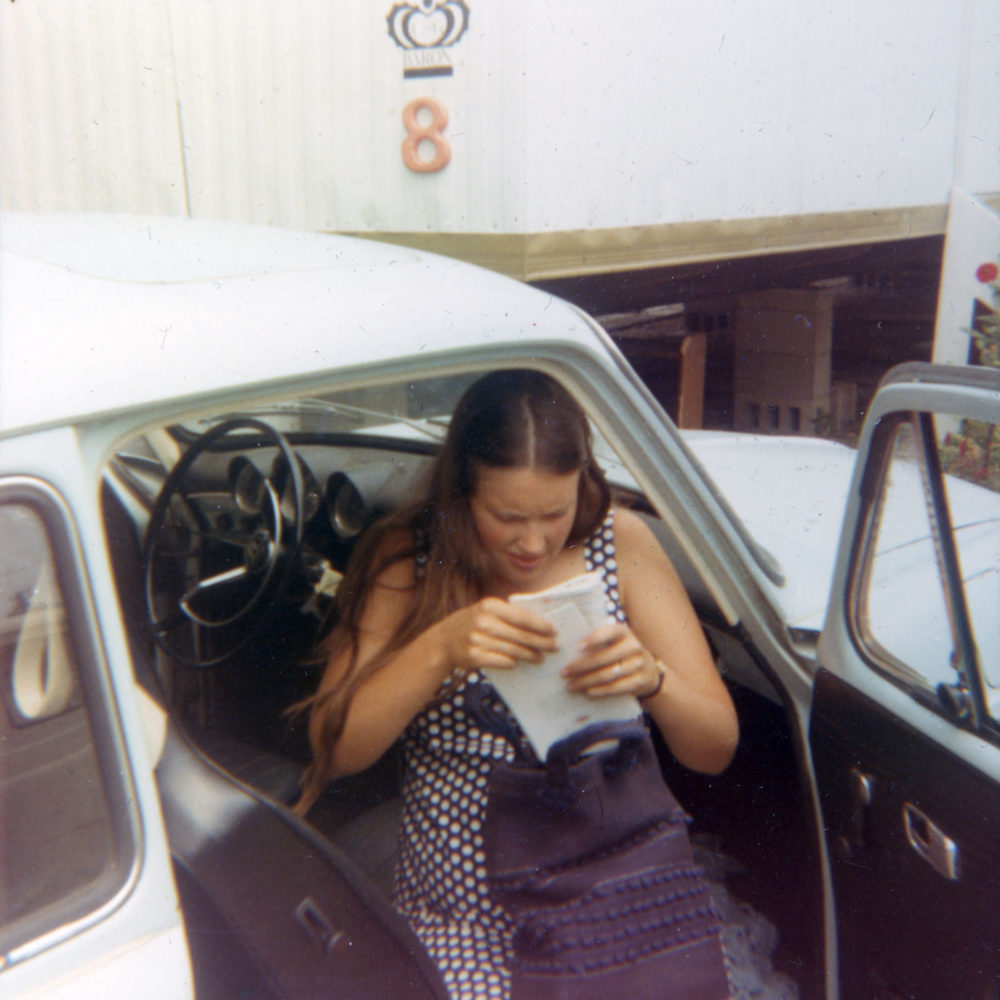 Pam with paperwork in Norm's car