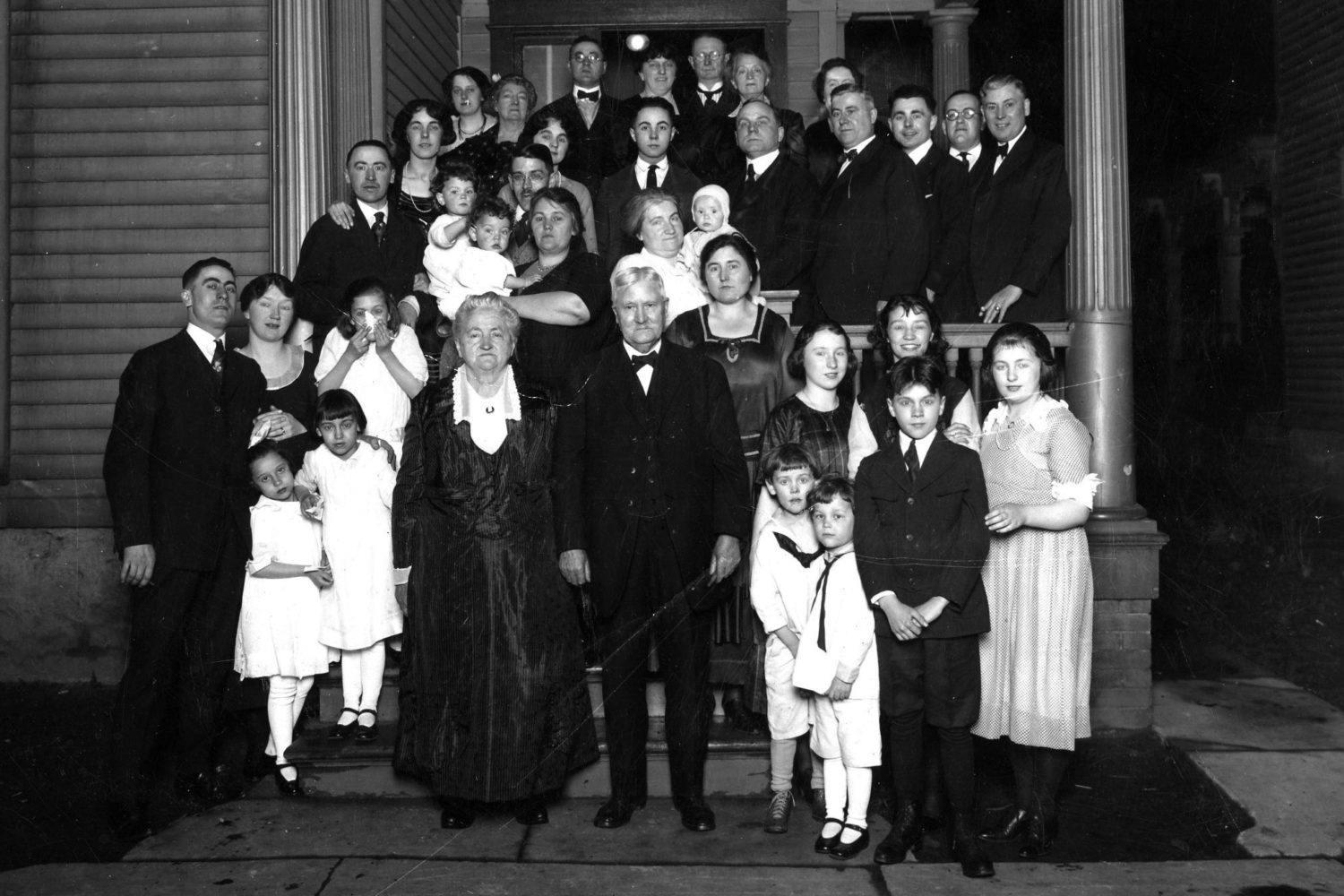 Ma and Pa Tierney celebrated their fiftieth anniversary at their house at 208 Lyndhurst Street in 1920.  Top row from left: Maime Tierney, Maney Moynihen, Raymond J. Tierney Sr., Mary Weitz, Andy Moynihen, Eleanor Nell (Tierney) Craddock, Emma Moynihen Foster Middle Row: Walter L. Tierney, Loretta Weitz, Lucille Weitz, Clare and Clive Lansing, Nell Lansing, Bernard Weitz, Ed's wife with Winifred, Gus Weitz, Edward J. Tierney Jr., Edmund Weitz, Mr. Foster, Joseph Bernard Tierney Front row: Arthur John Tierney, wife Anna Tierney, Winifred Lansing, two young girls are Rita Tierney and Elizabeth Lansing, Ma and Pa (Edward J. Tierney and Winifred Maloney) Tierney, Elizabeth M."Betsy" Tierney, Mary Tierney, Jane Lansing., Margaret Tierney, two boys in white are Bob and Dick Lansing, Gerritt Lansing. > Suzanne Tierney, Art Tierney's daughter, provided identification. 