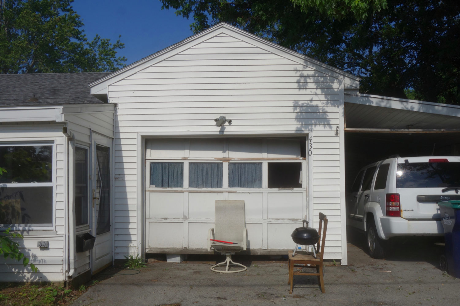 Barbecue on chair in the driveway