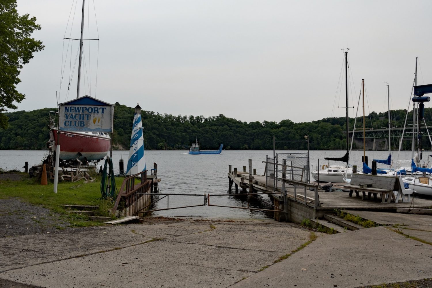 Blue boat in bay by Newport Yacht Club