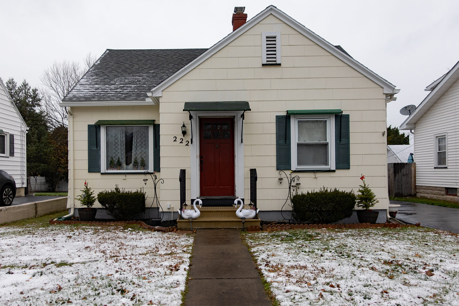 Yellow  house with two swans