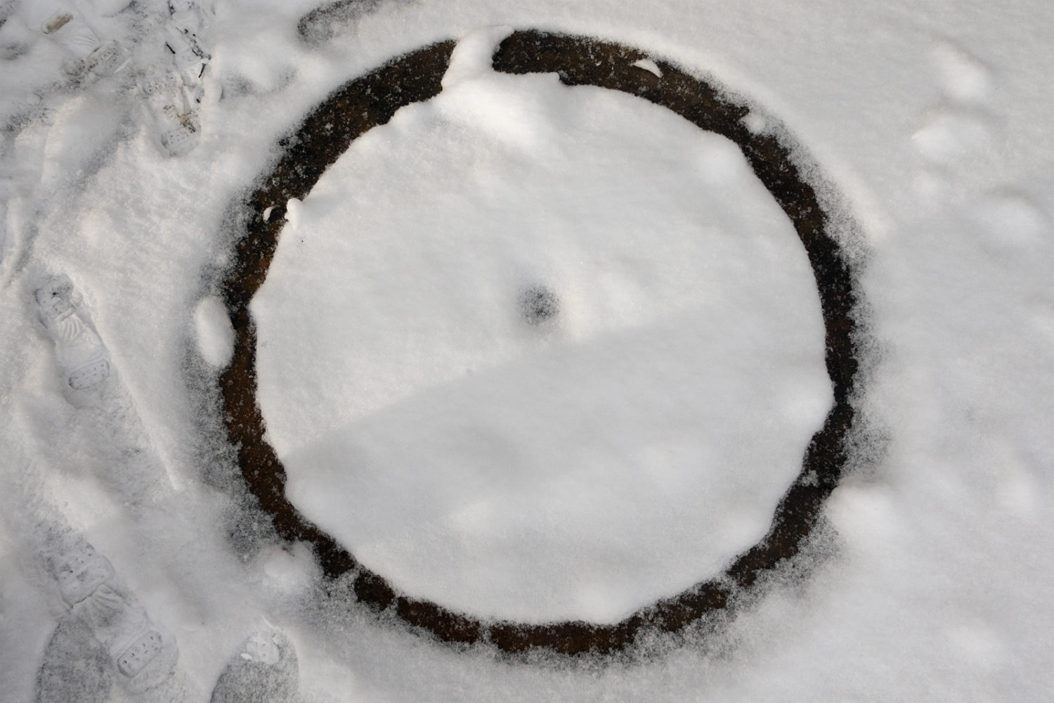 Black circle in the snow on Seneca Park Bridge
