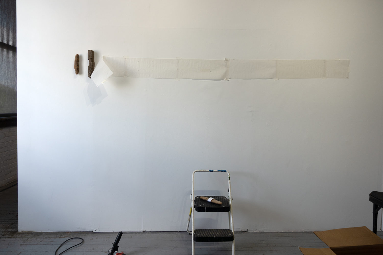 Hanging Los Inmigrantes at Colleen Buzzard's Studio in Anderson Arts Building
