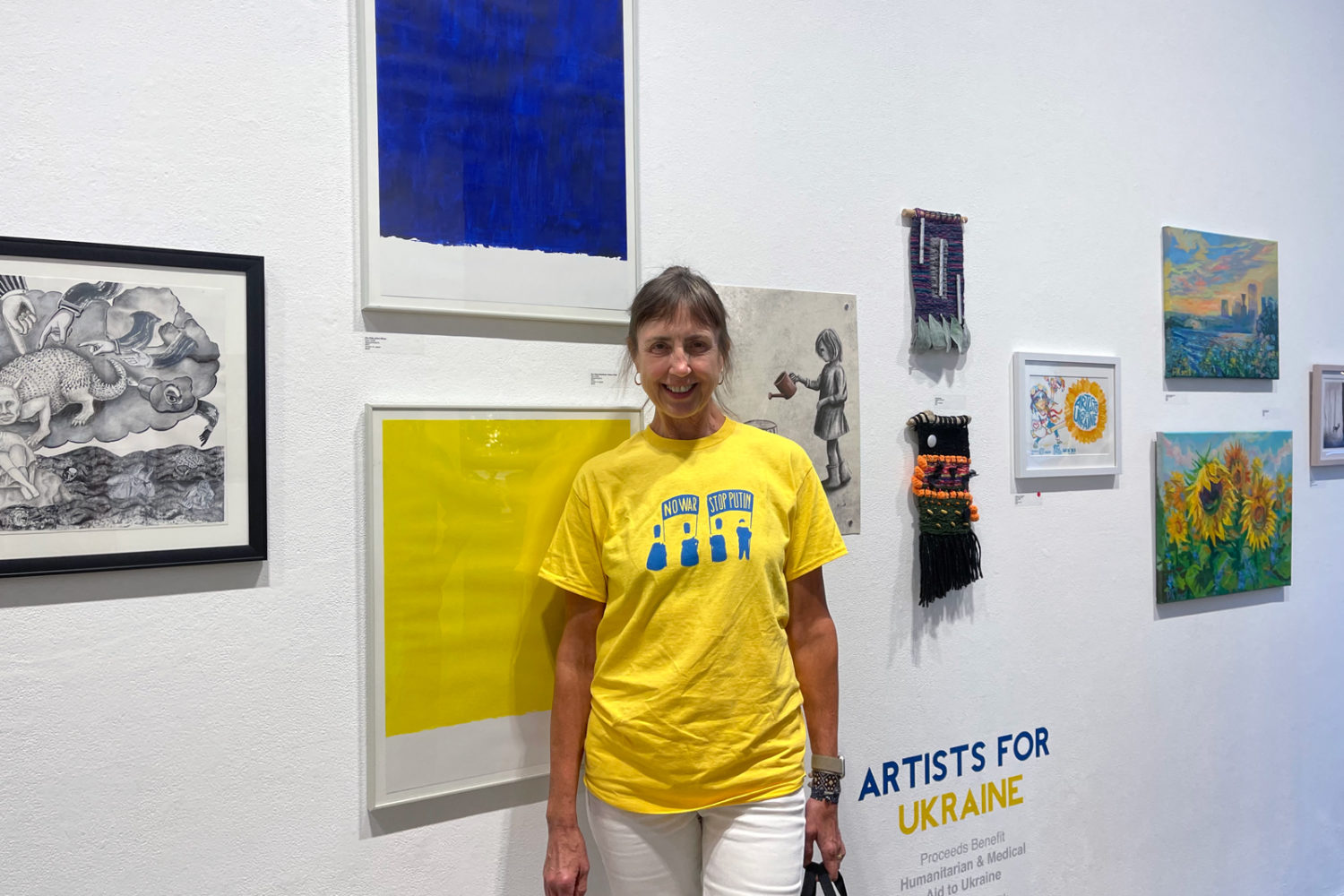 Olga in front of my two  contributions to "Artists For Ukraine" show at Rochester Contemporary