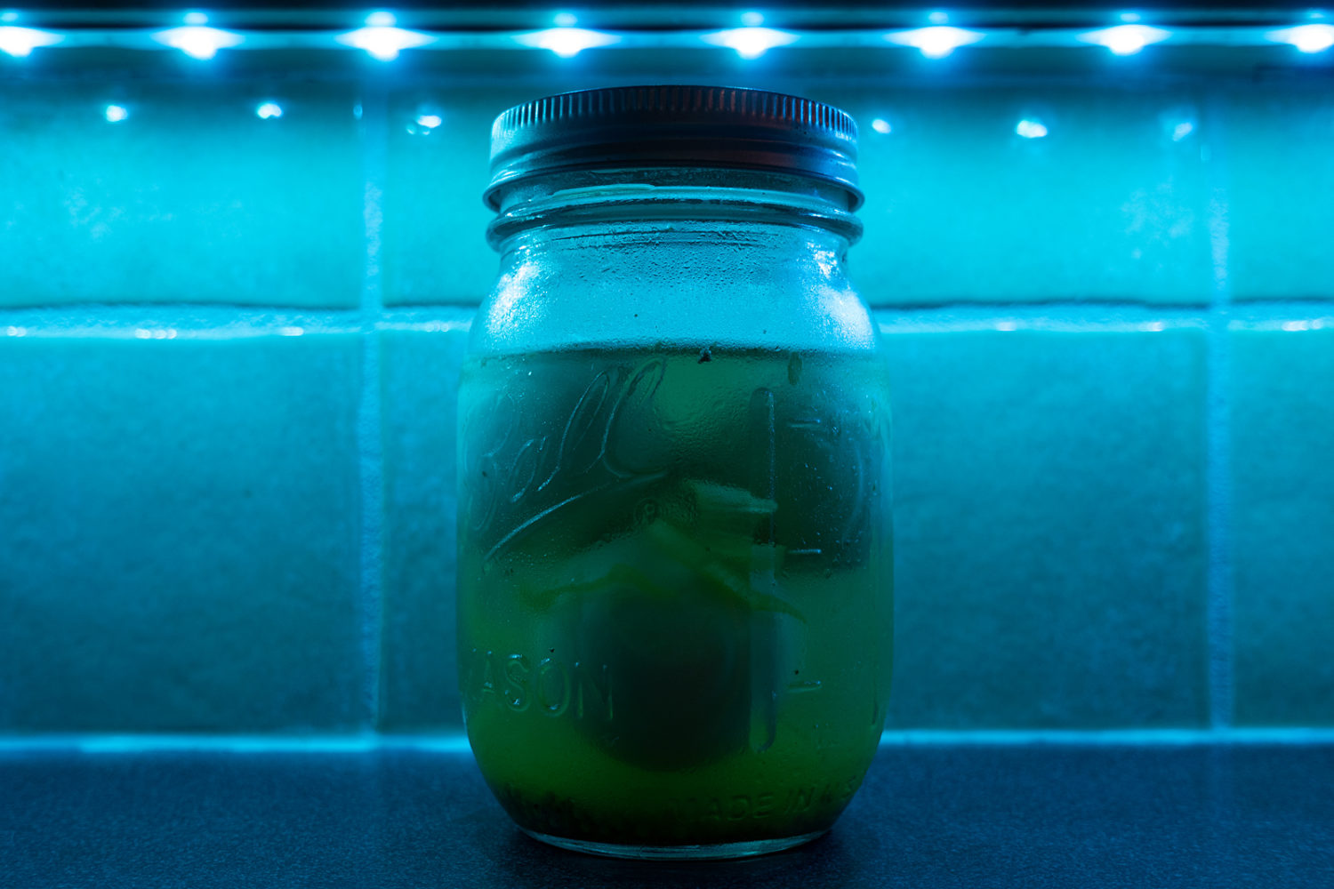 Pickled eggs under blue light in the kitchen