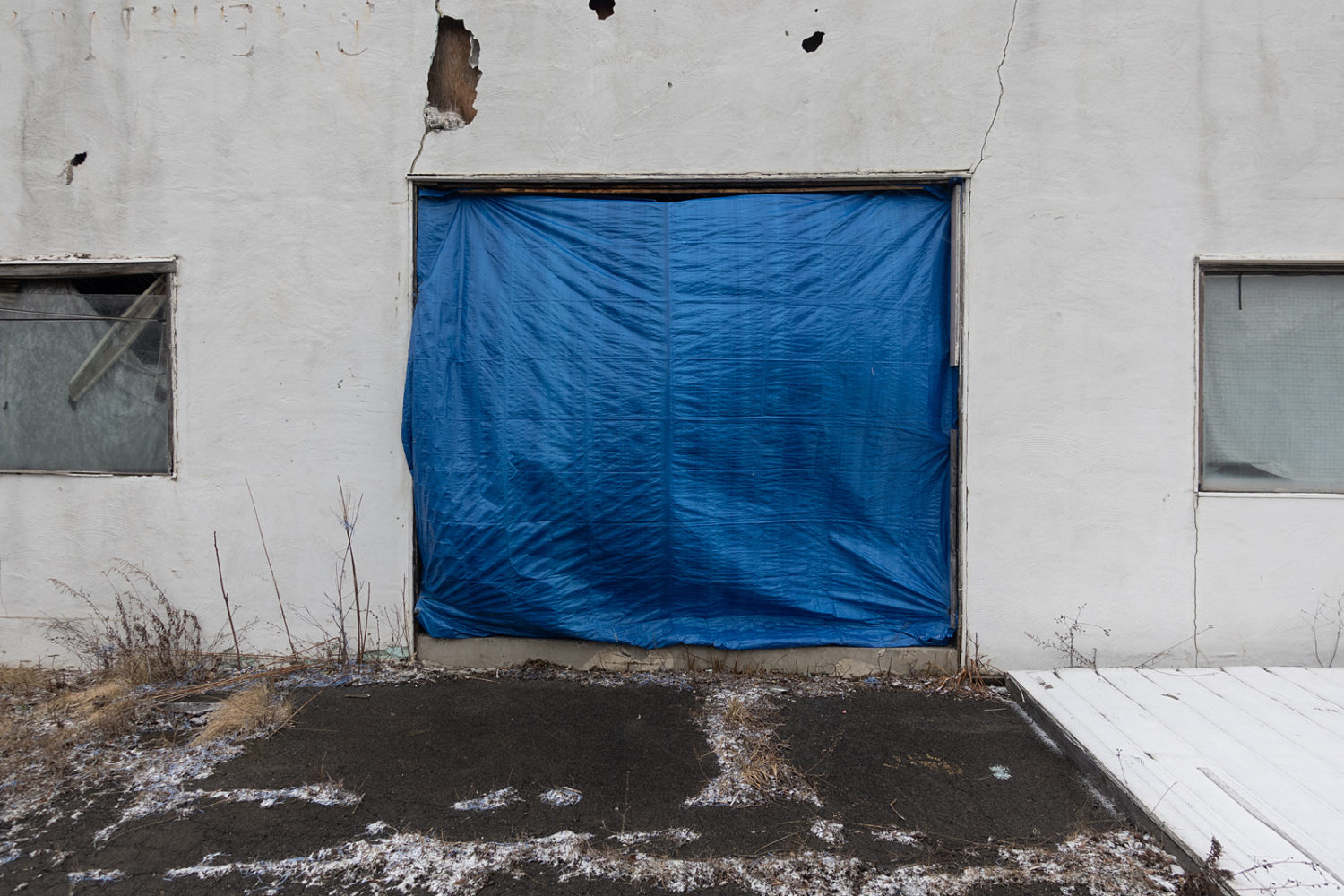 Blue tarp installation along road to Ithaca, New York