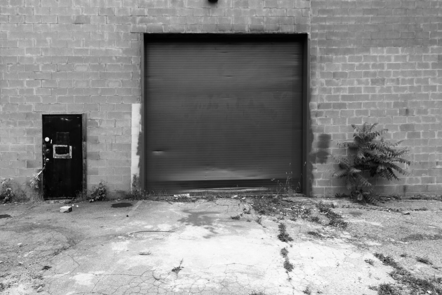 Red overhead door on Hudson Avenue with Film Noir filter