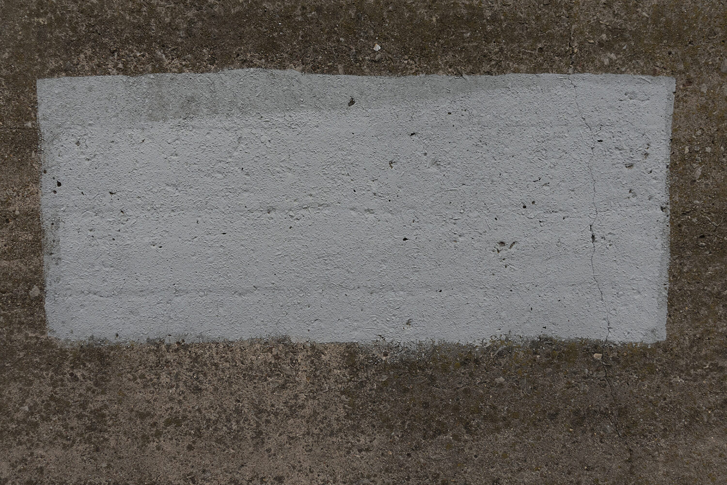 Grafitti cover-up paint on wall under railroad bridge on Winton
